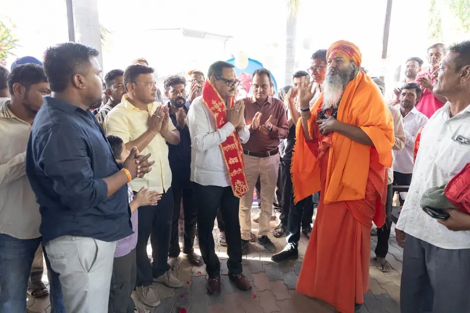 Group with sadhu, folded hands