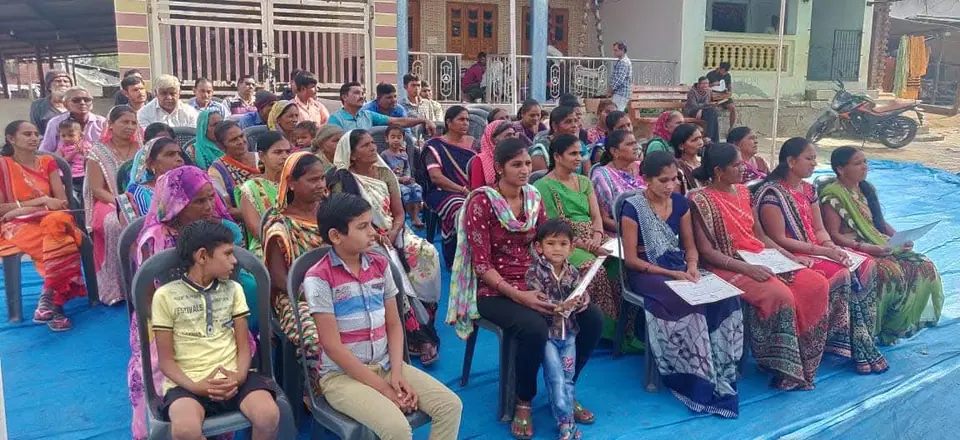 Women seated at programme