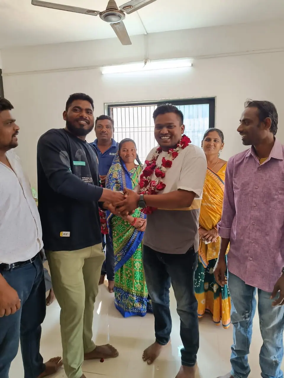 Garlanded men indoors