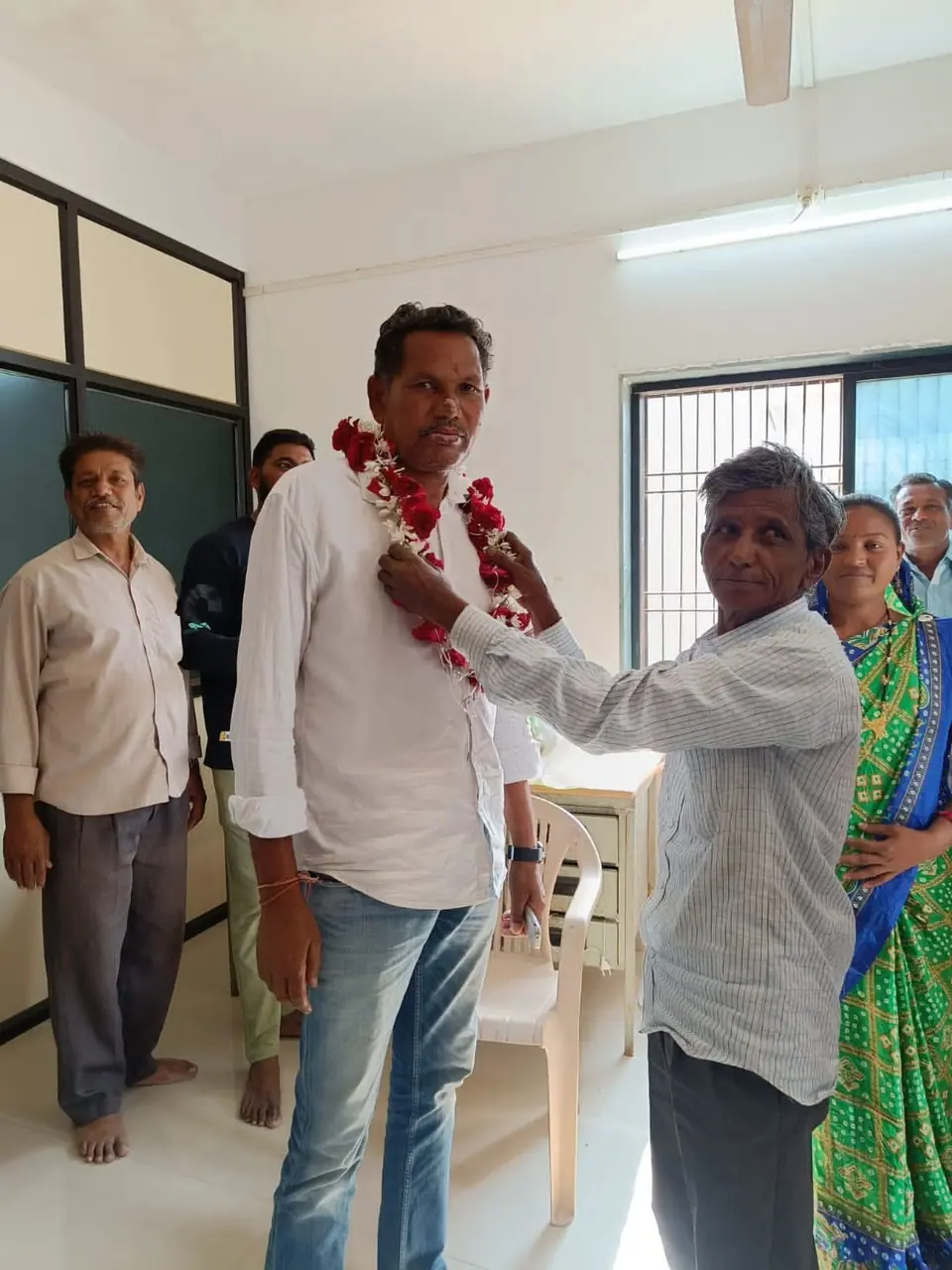 Garlanded men indoors