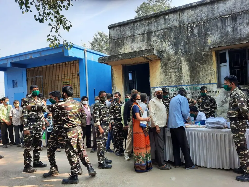 Camp with uniformed personnel at building