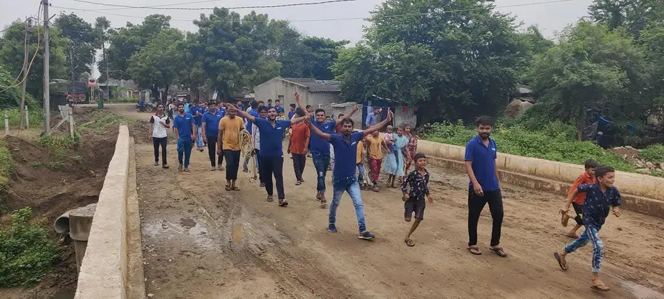 Group running/walk in blue t-shirts on village road
