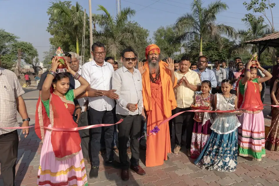 Ribbon cutting with girls in traditional dress and sadhu