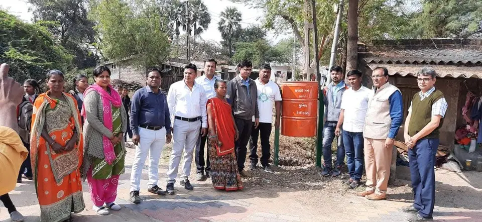 Group with schoolchildren near dustbin
