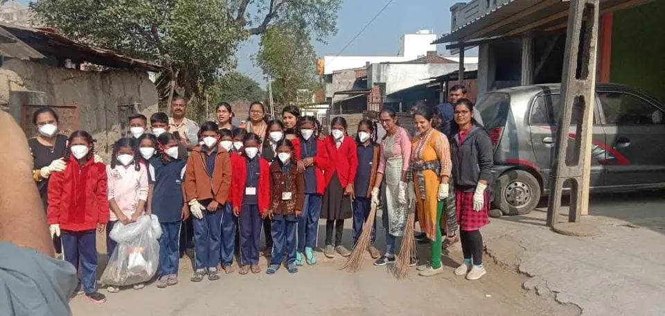 Schoolchildren in masks with brooms
