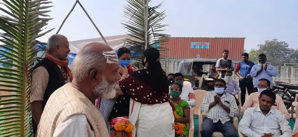 Elder being greeted at programme