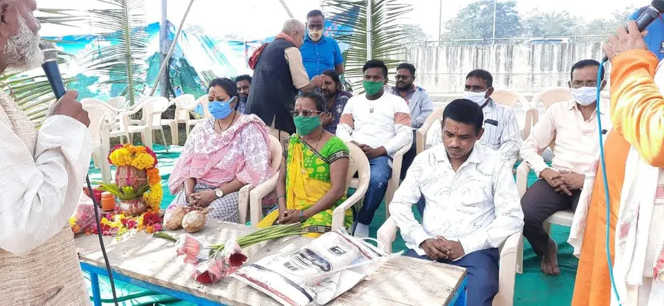 Guests seated with flowers, programme