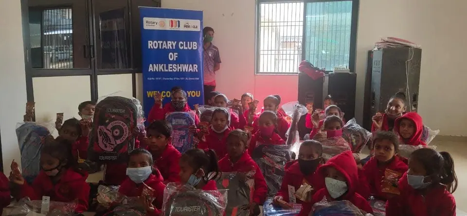 Children with gift bags, Rotary Club banner