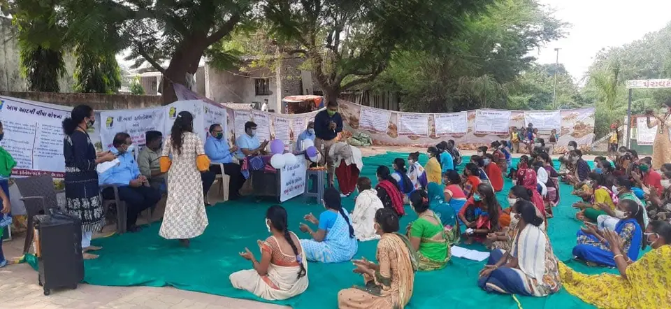 Awareness camp, seated women, banners
