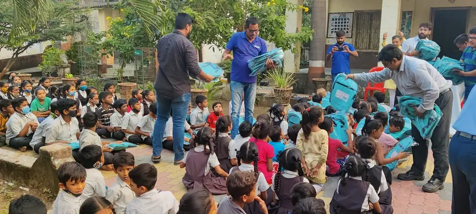 School bag distribution, children seated