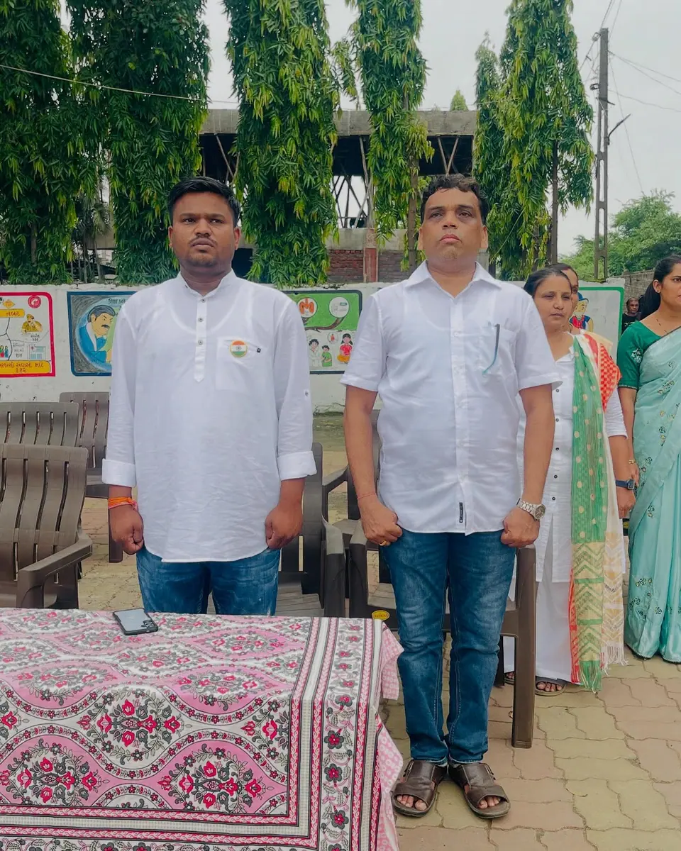 Two men standing at school event table