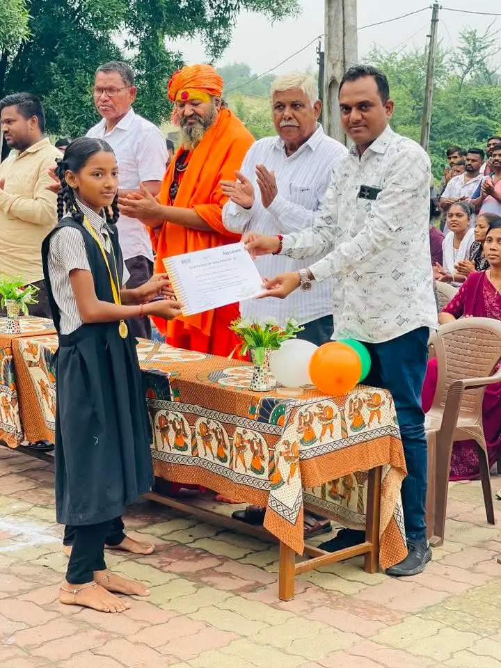 Prize/certificate to schoolgirl, sadhu present